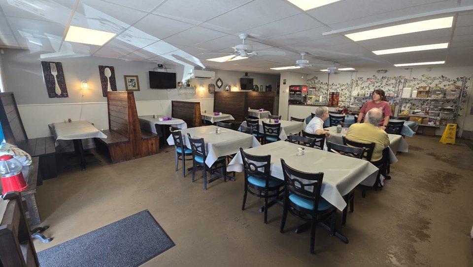 Bright interior with family-style restaurant seating.